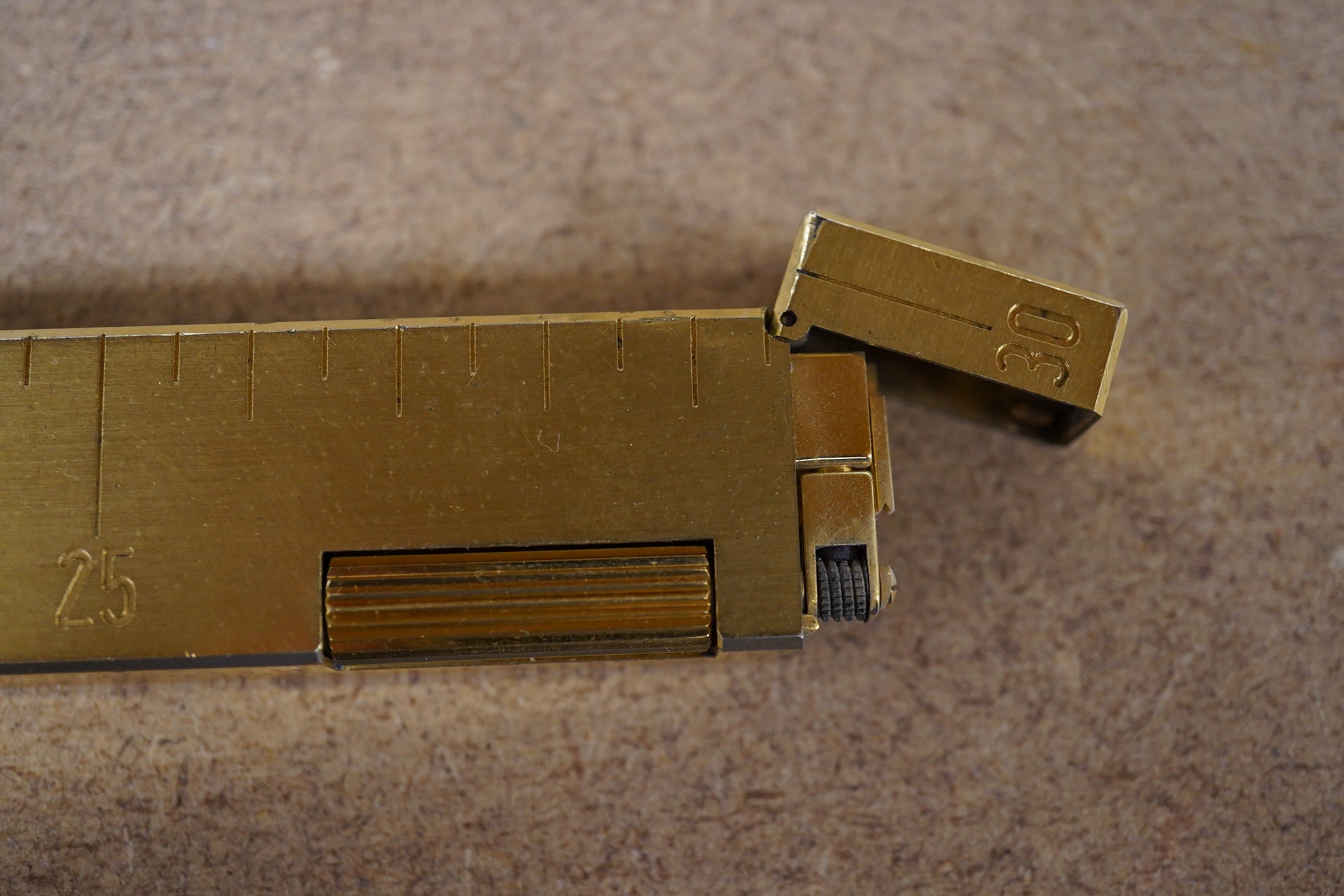 A gilt metal Dunhill 'ruler' lighter, 30cm in length. Condition - good, not working